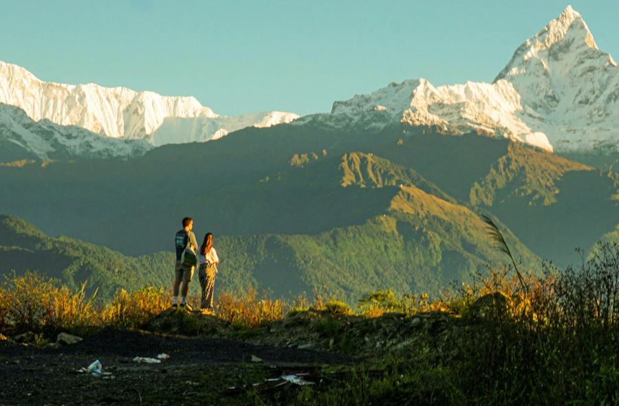 Two people standing together on a mountain ridge