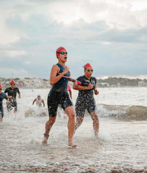 Swimmers running out of the ocean