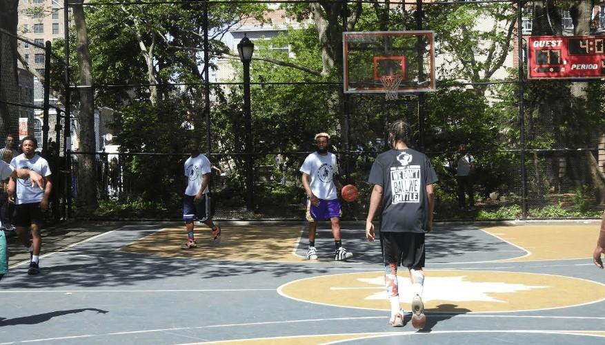 A group playing basketball outdoors